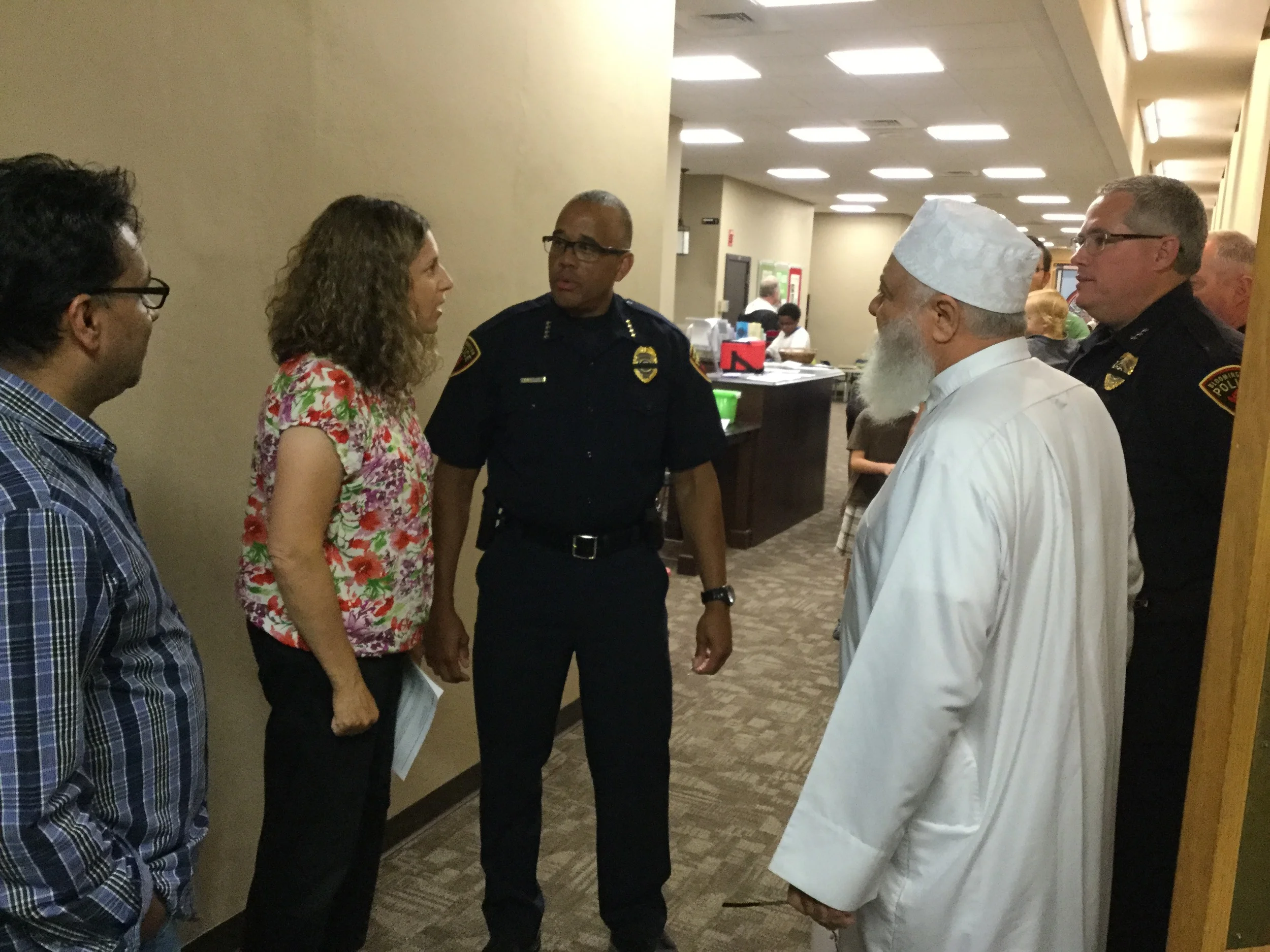 Moses Montefiore Rabbi Rebecca Dubowe and Imam Abu Emad AL-Talla chat with Bloomington Police Chief Brendan Heffner prior to the vigil.