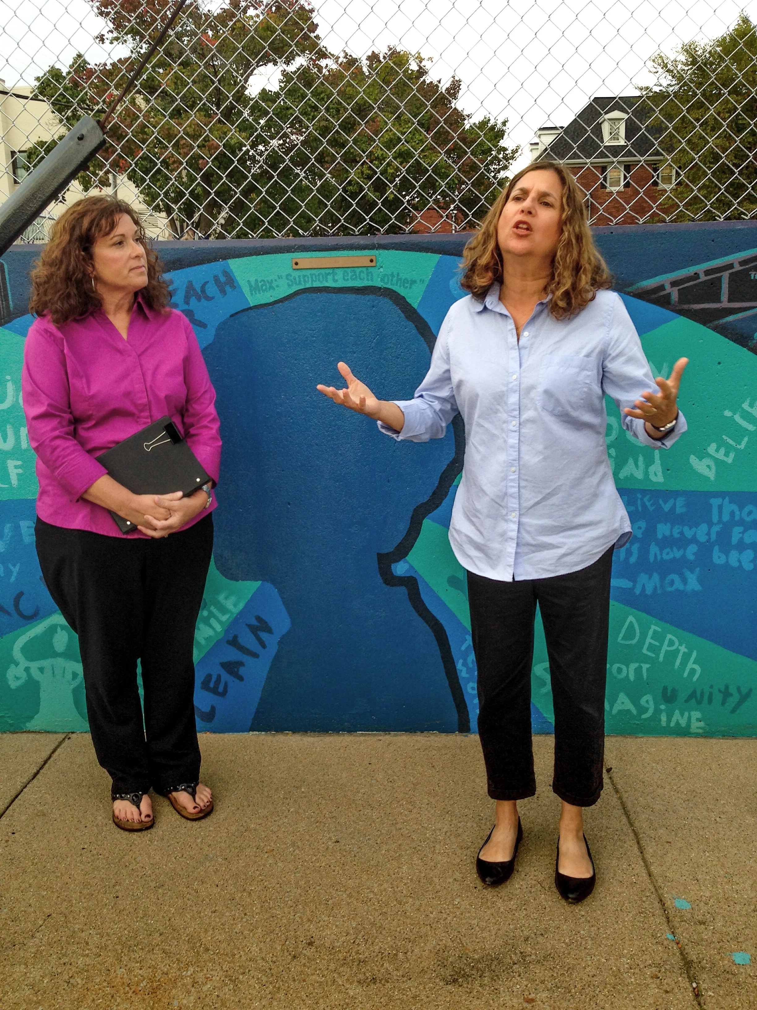 Moses Montefiore Congregation Rabbi Rebecca Dubowe, right, offers a blessing for the mural along with Bloomington First Christian Church Rev. Kelley Becker.