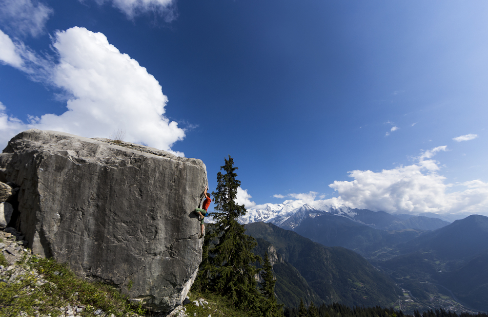  Tommy Caldwell bouldering with the Mont Blanc Massif behind. 