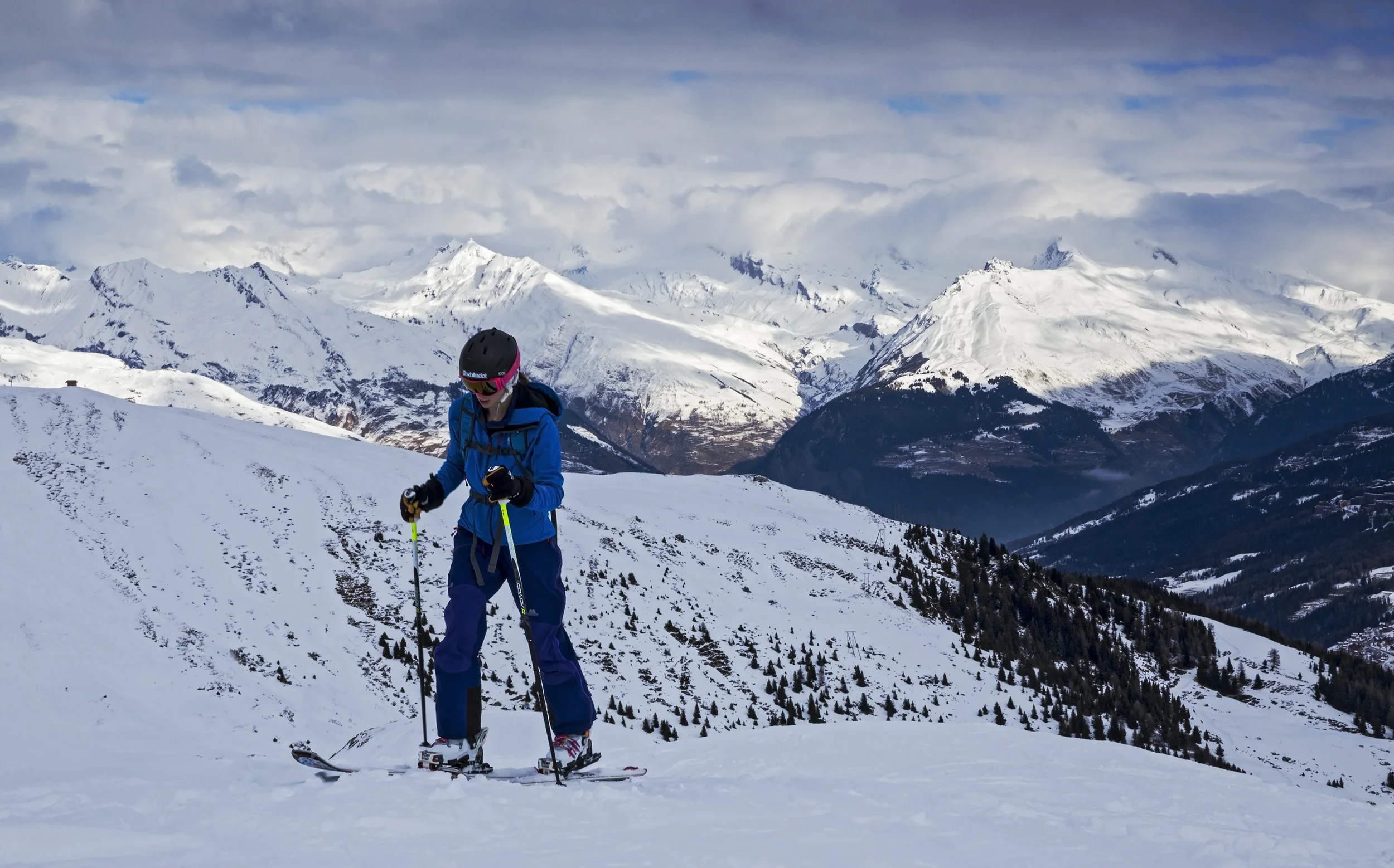 Natalie Berry skinning up the slopes above Montchavin with Mont Blanc buried in cloud behind. Shot on a Canon 6D with a 24-70 and Lee .6 Soft Grad.