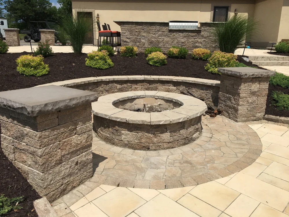 Patio contractor Syracuse paver patio with fire pit, retaining wall and plantings