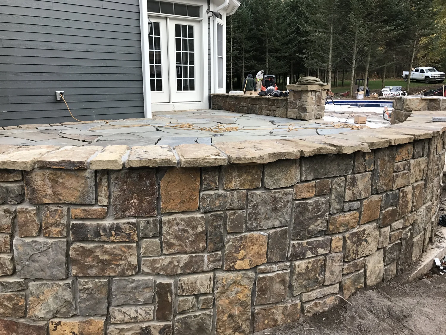 Hardscape contractor Syracuse curved natural stone seating wall with cap