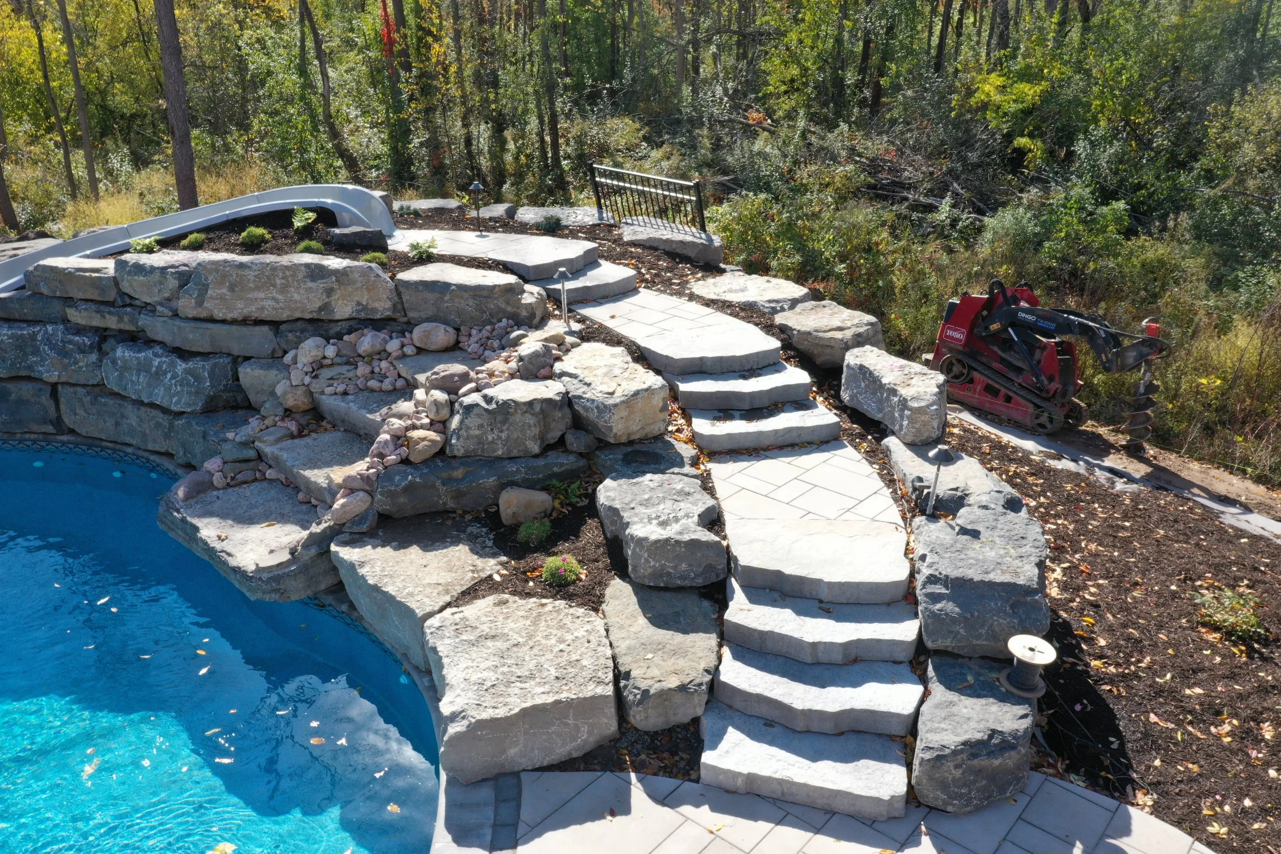 Pool-design-syracuse-waterfall-slide-techo-bloc-maya-boulder-steps-landscaping.JPG