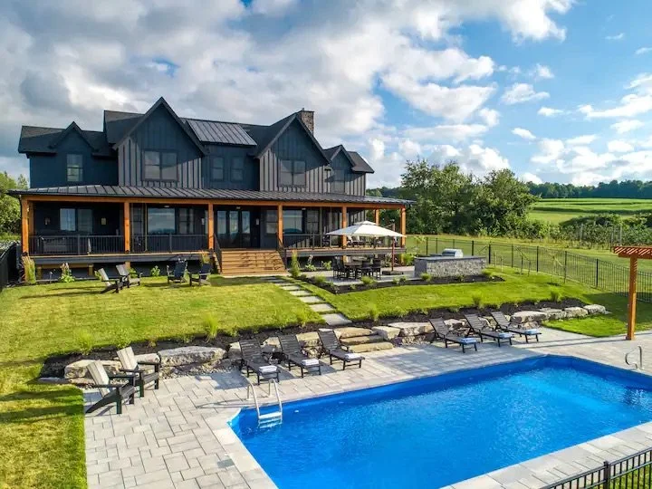 Pool and patio landscaping with boulders on a large Central NY property