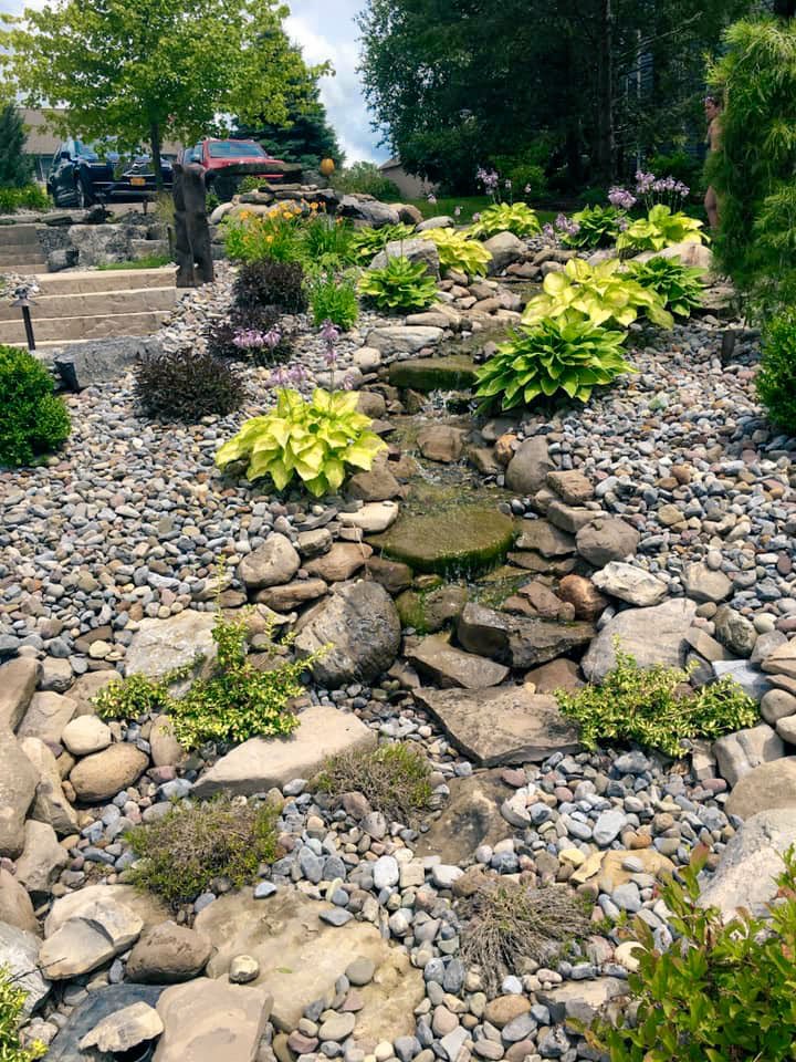 Pondless waterfall water feature Syracuse with natural stone, flagstone, boulders and hostas