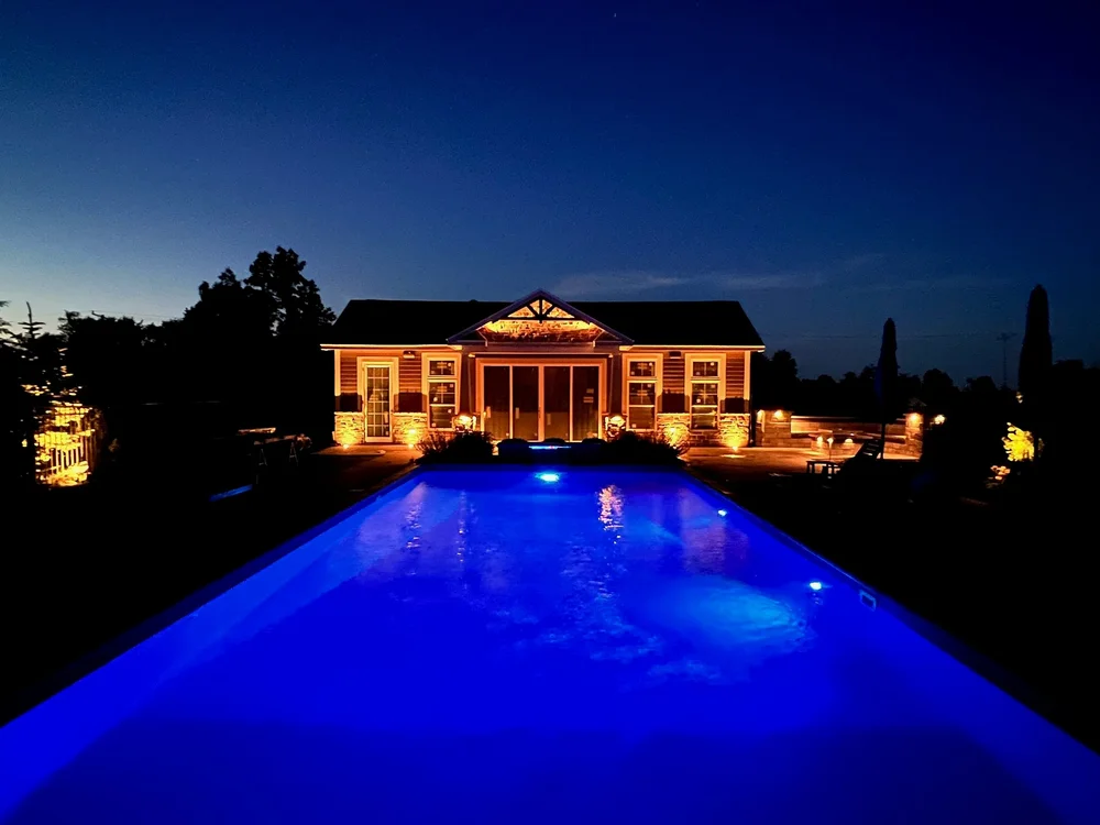 Landscape lighting installer Syracuse pool house and pool lighting at night