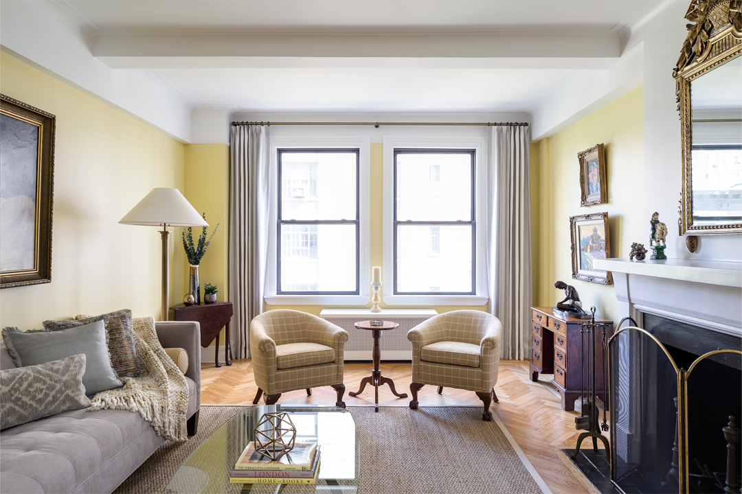 This is a pretty good starting point, but there are some issues I wanted to fix. I love the direction of the natural light, creating interesting shadows especially on the seating area, pillows and throw, but the amount of natural light needed to light the whole space creates over exposure in some areas. You can see there is a loss of detail in the paintings on both sides of the room, the yellow walls, the desk, and the wood flooring closest to the window.