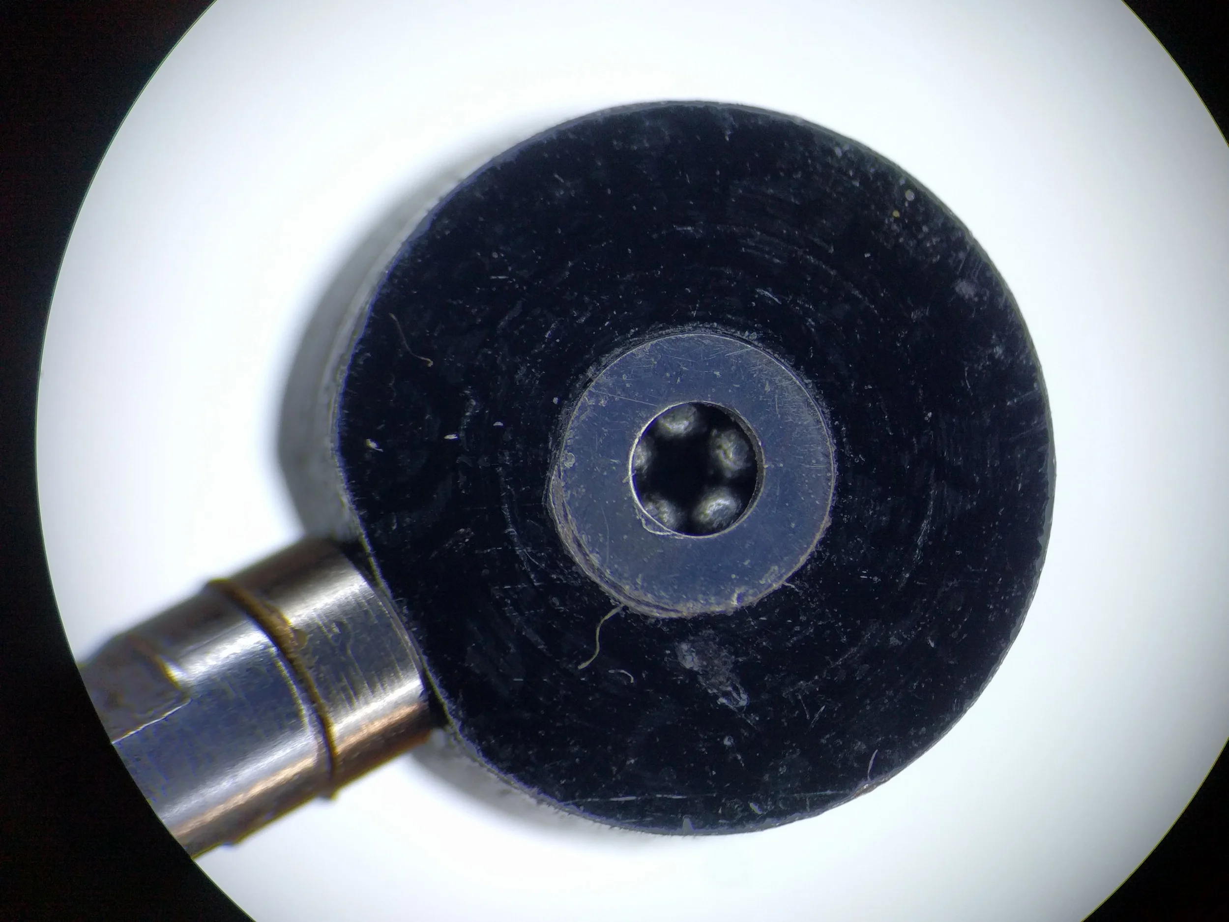 Detail of the bearing balls inside the pivot assembly. These are roughly 0.03" in diameter.