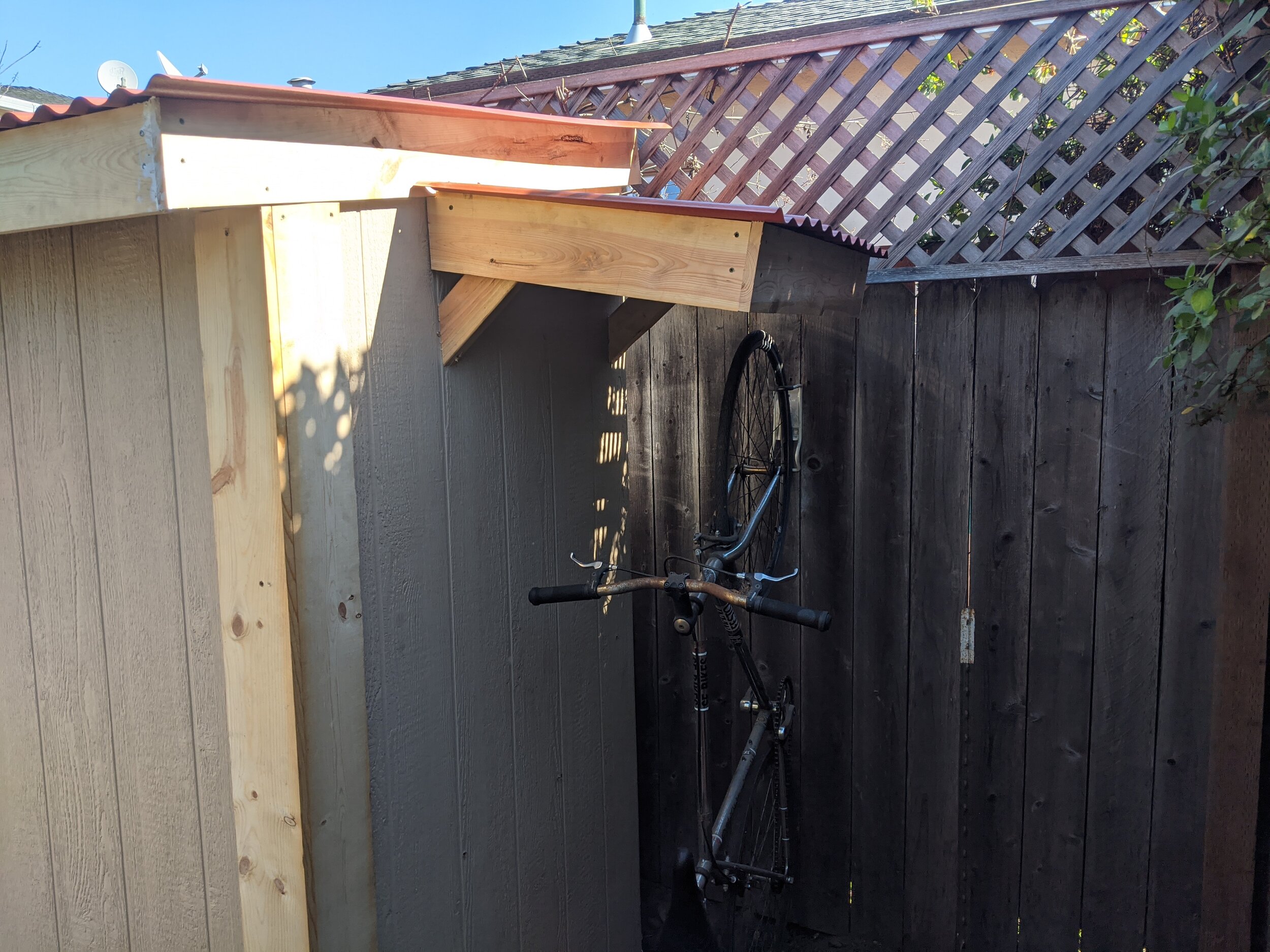  Once the rest of the shed was complete, I built a small roof out of scrap to protect my wife’s bike from the rain. 