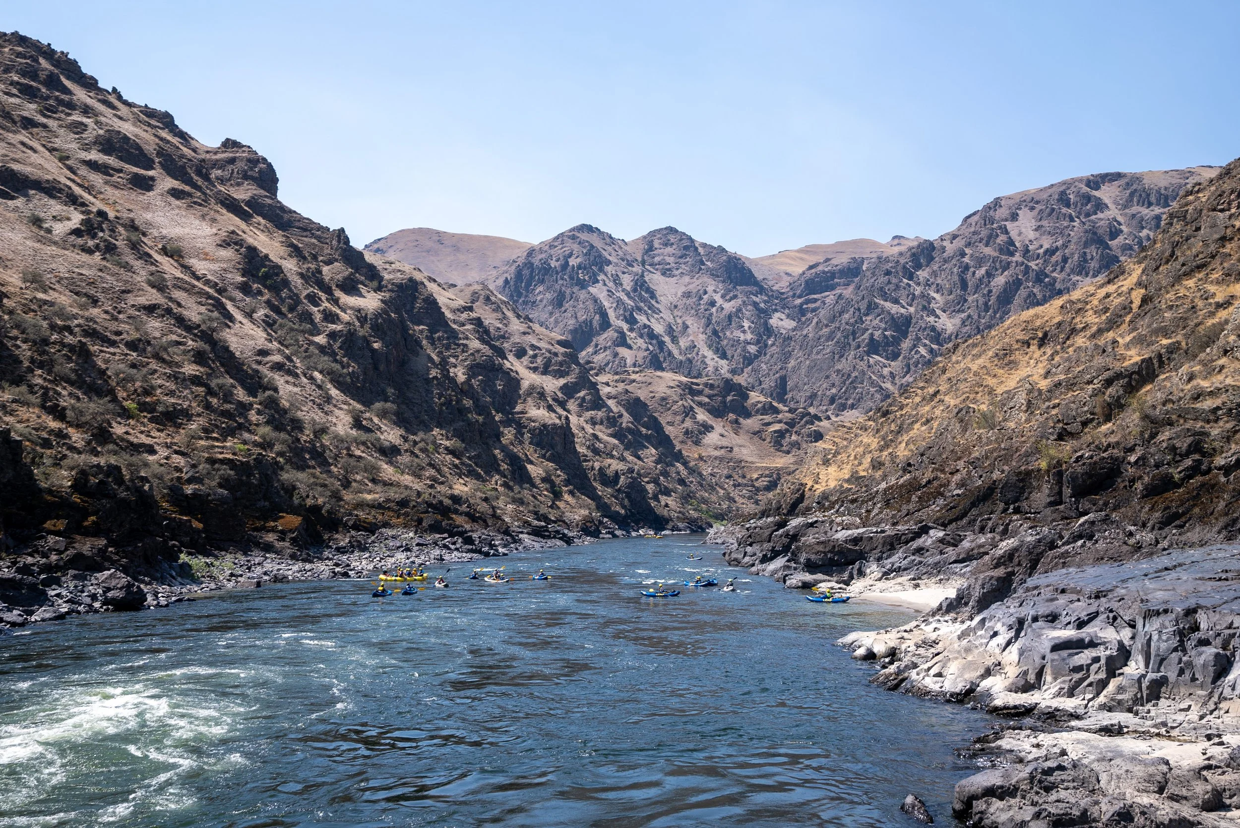 Youth in individual inflatable kayaks on the Lower Salmon River in Idaho.