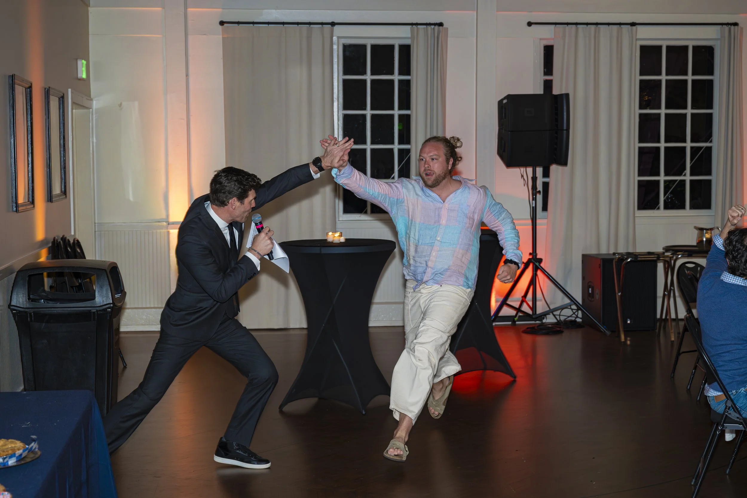Two people are high-fiving during the dessert dash portion of the Variety Show event.