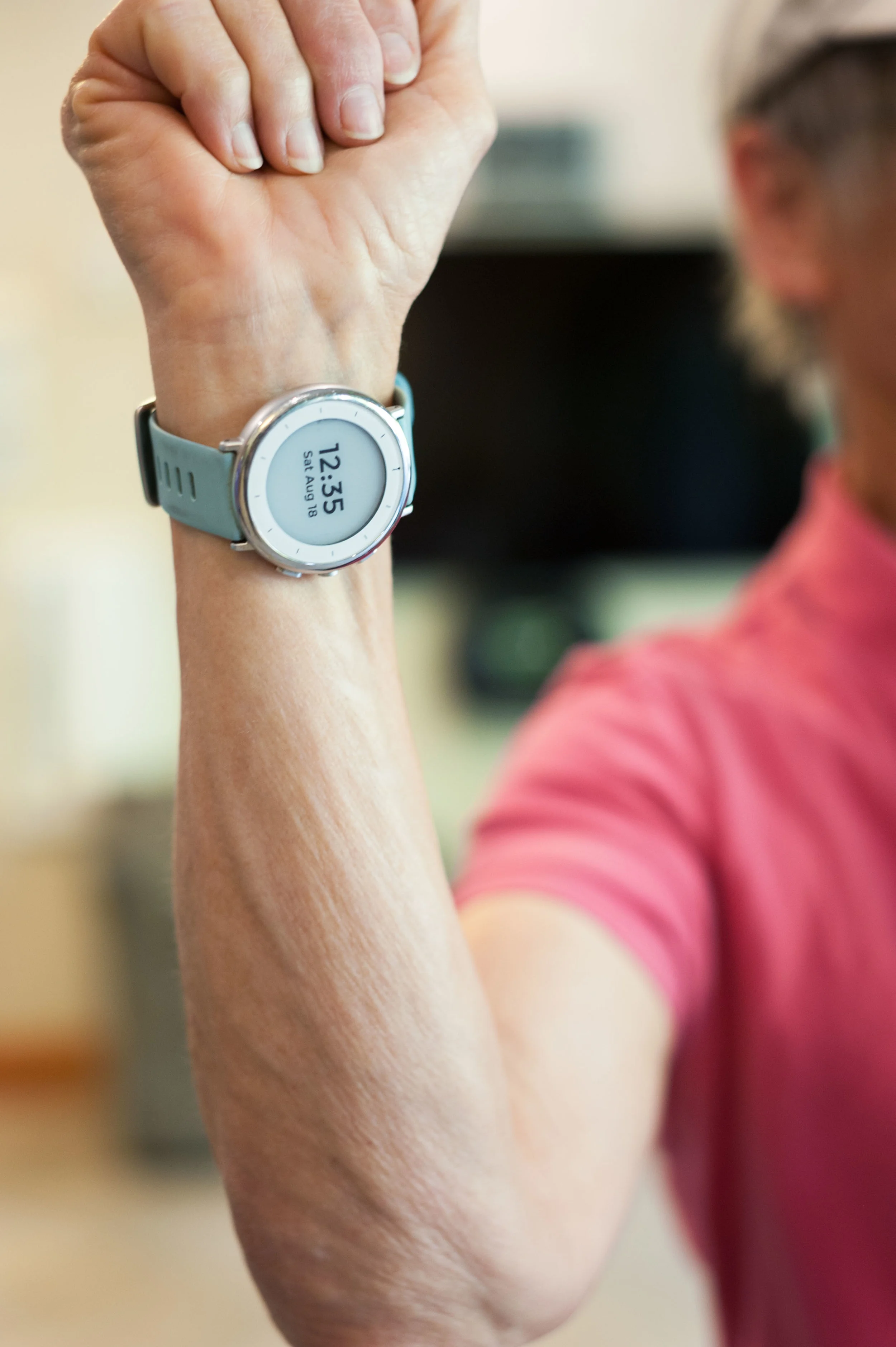 A participant in Stanford University’s Project Baseline Study shows off her investigational study watch, designed to monitor her sleep and activity.