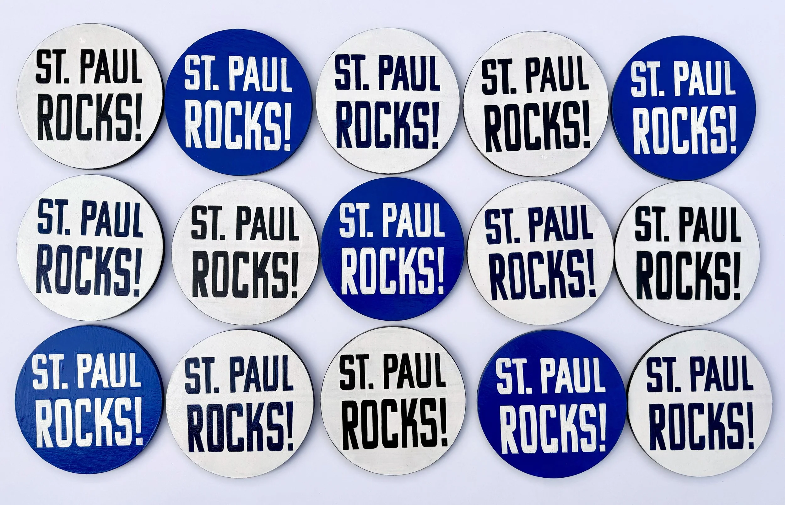 Blue and white sign painted circles that say 'St. Paul Rocks!