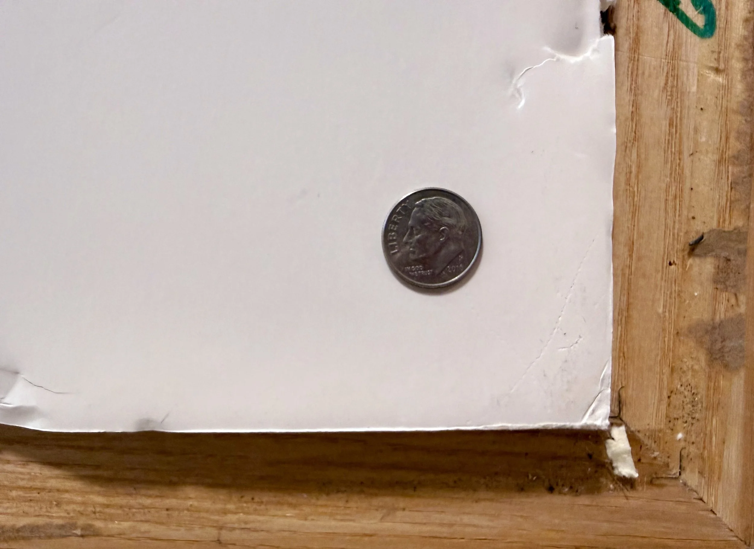 A US dime on a framed piece of mattte board.