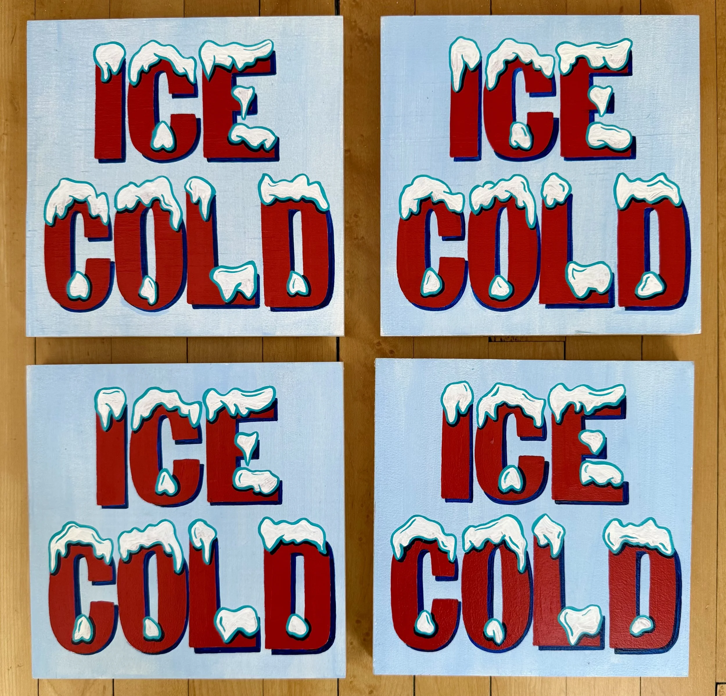 Four light blue signs that say ICE COLD in red snow-capped lettering