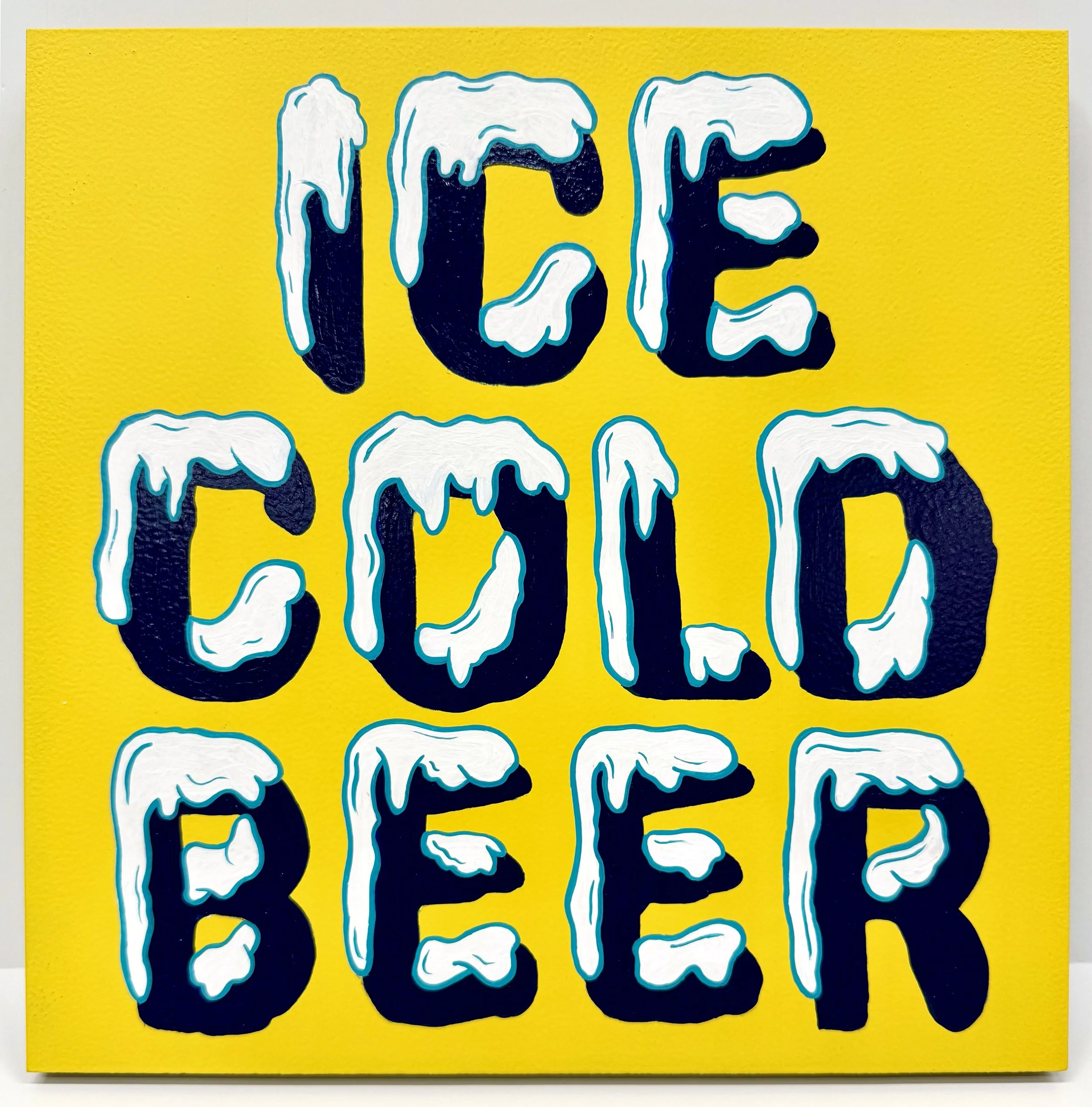 Ice Cold Beer painted with snow capped lettering on a yellow board