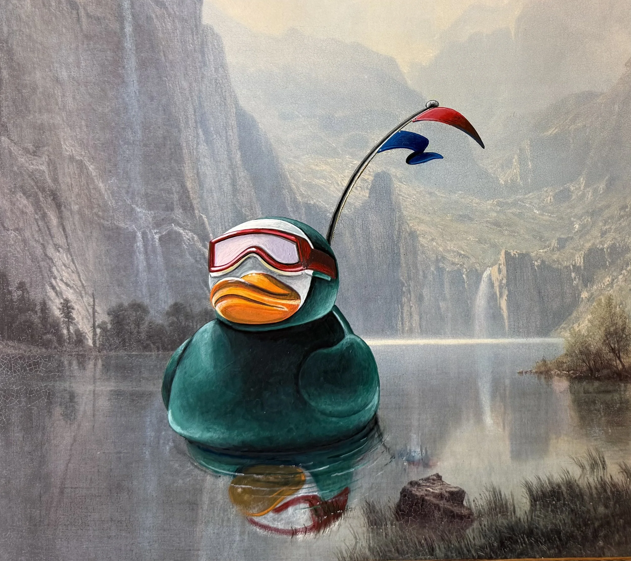 A painting of a rubber duck floating in a lake wearing a green wetsuit and goggles with red and blue burgees.
