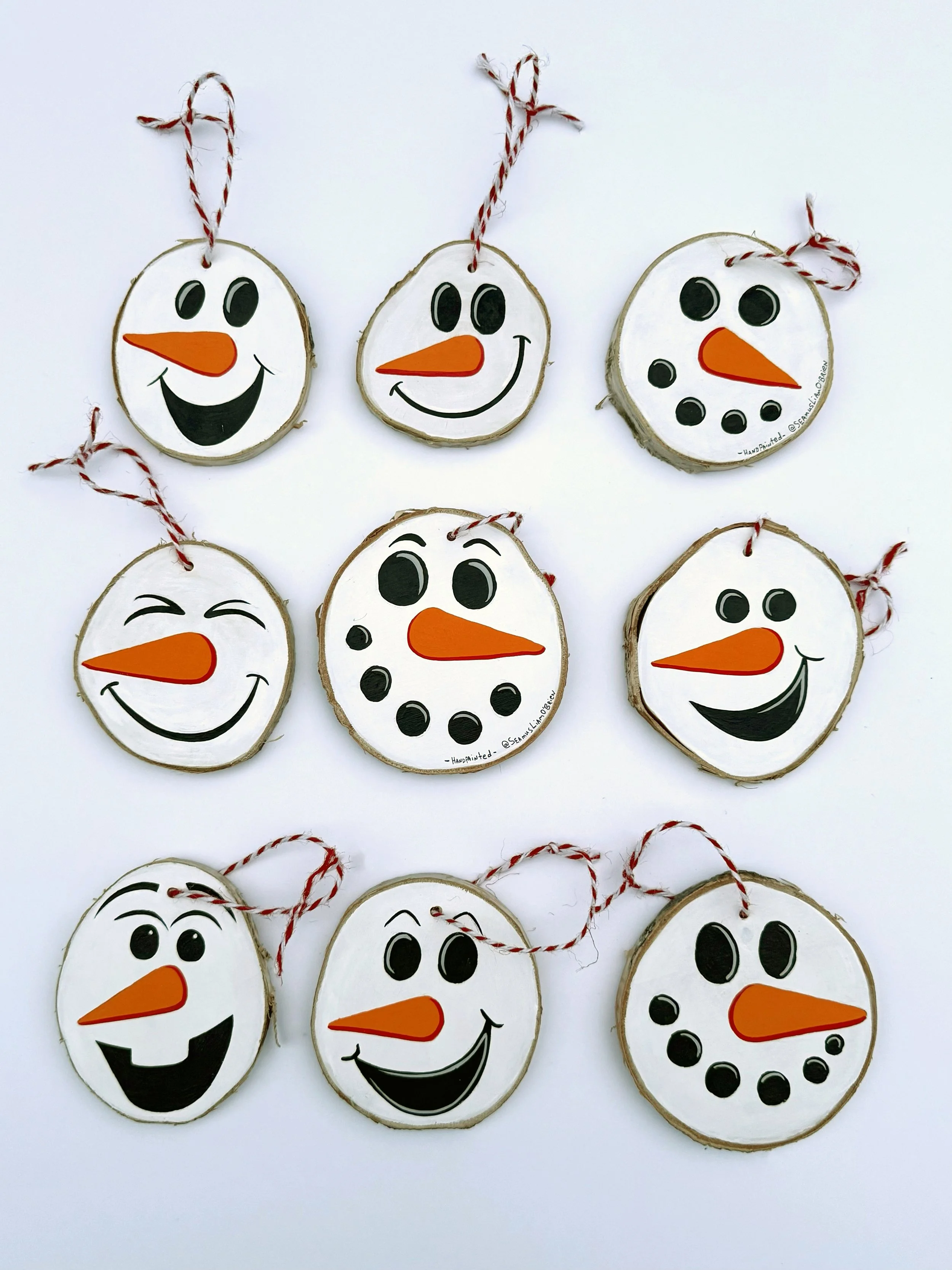 Nine snowman tree ornaments that show various facial expressions