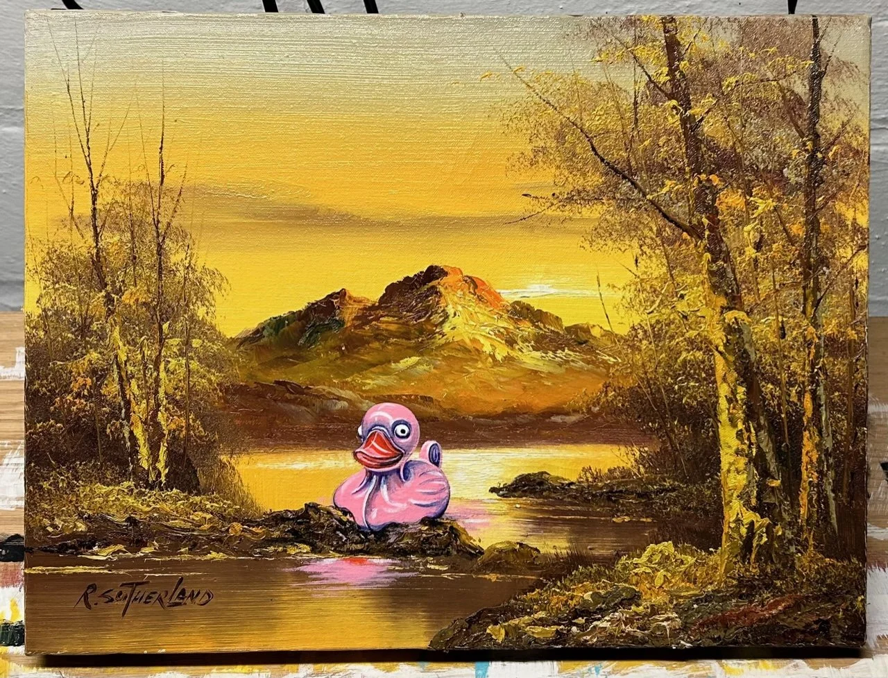 Pink rubber duck painted onto a R. Sutherland landscape painting