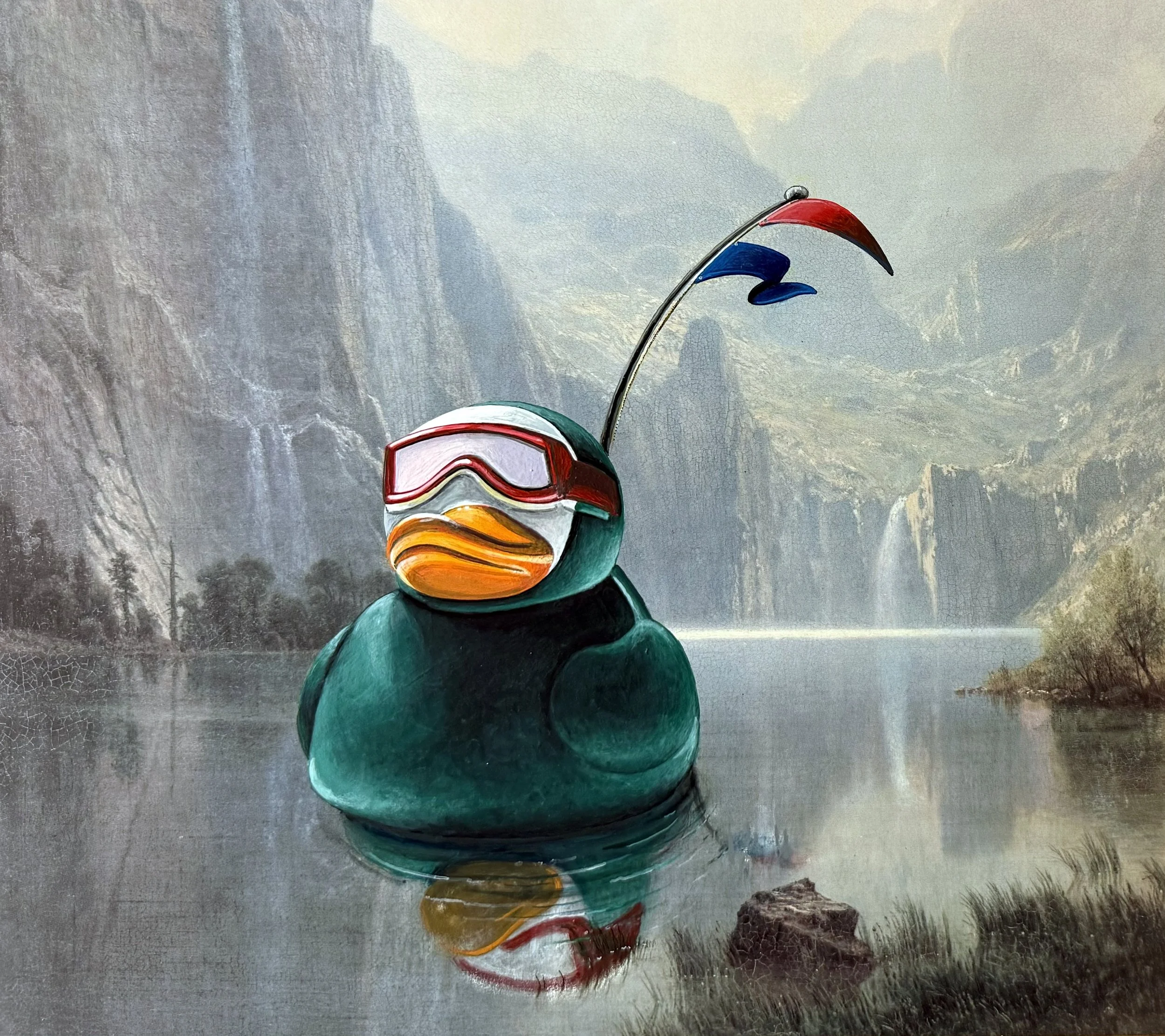 A painting of a large rubber duck wearing a green wetsuit, goggles, and flying red and blue burgees, floating on a river