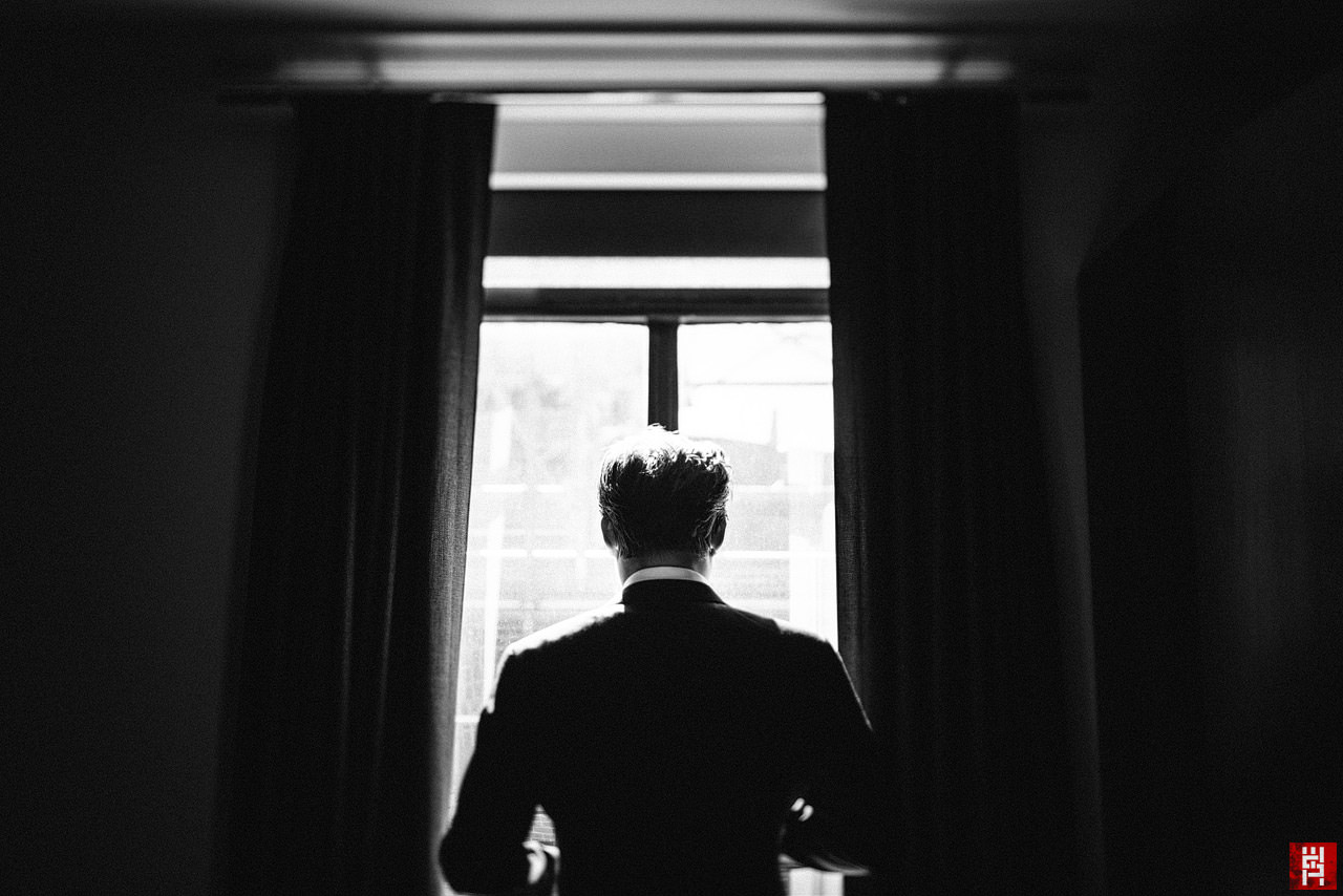 028-groom-tilt-shift-getting-ready-portrait-window-drama.jpg