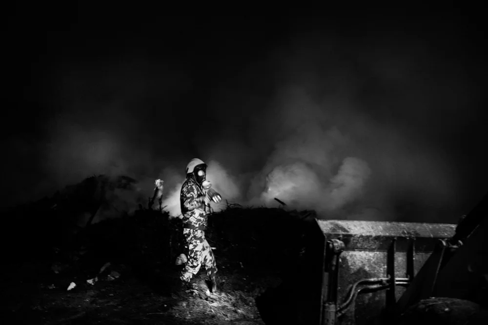  Fireman extinguishing a fire after clashes between Israeli security forces and Palestinians in the neighborhood of Anata on the outskirts of Jerusalem. 2013. 