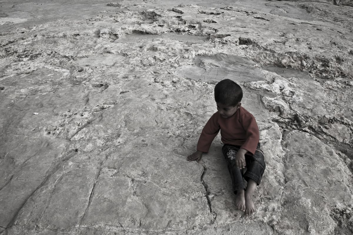 Naseem playing in the backyard of his home. Naseem is suffering from a paraplegia at the lower part of his body, as a result of the presence of water in is brain. He is a patient at the rehabilitation center supported by Handicap International in Ya