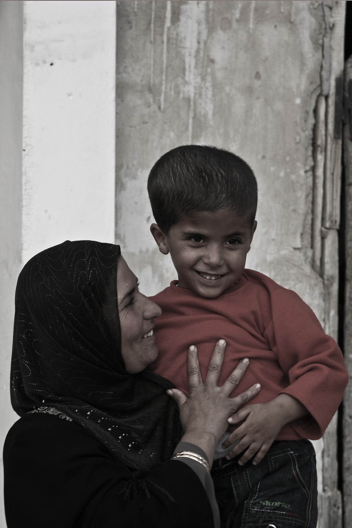 Naseem with his mother. He is suffering from a paraplegia at the lower part of his body, as a result of the presence of water in is brain. He is a patient at the rehabilitation center supported by Handicap International in Yatta.