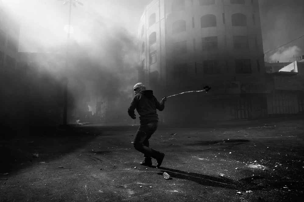  Palestinian stone thrower during clashes with the Israeli troops in Hebron. 