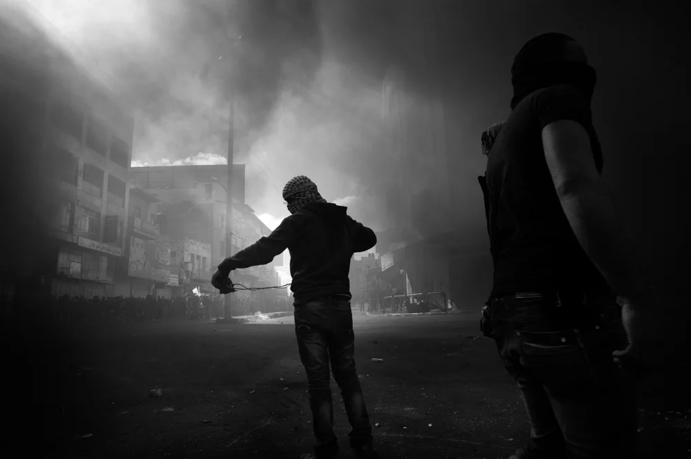  Palestinian stone thrower during clashes with the Israeli troops in Hebron. 