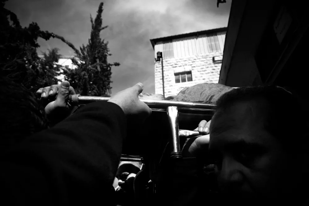  Relatives of Saji Sayel Darwish carrying his body from the Ramallah Hospital to his native village of Beitin. Saji was shoot the night before after supposedly attacking Israeli soldiers on the road to Ramallah. 11/03/2014 