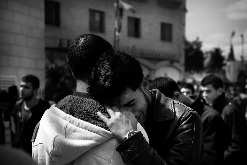  Friends mourn the death of Saji Sayel Darwish. Beitin; Palestinian Territories; 11/03/2014 