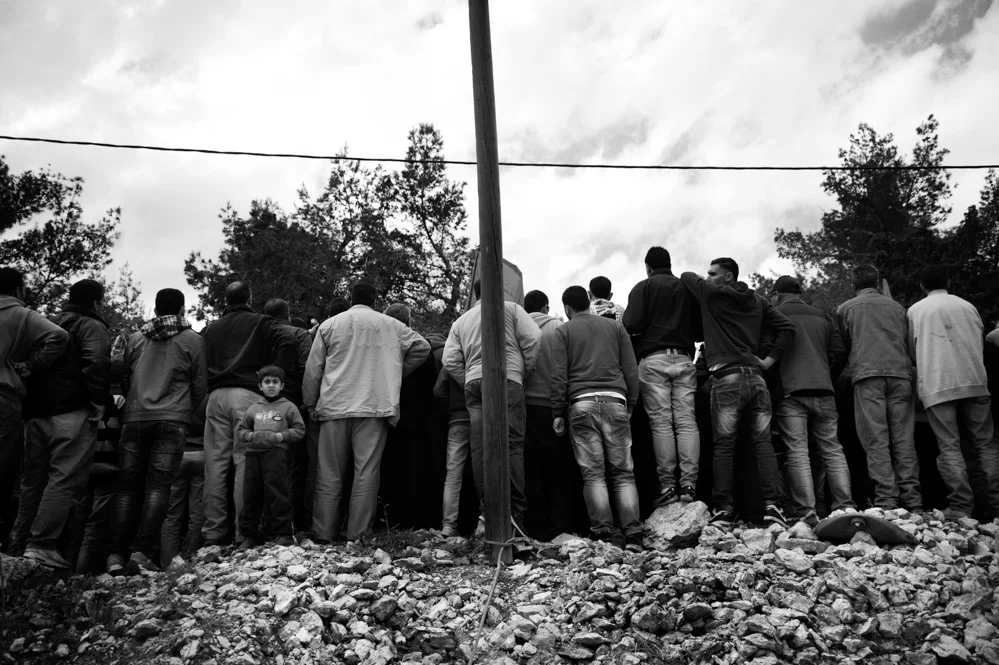  People attend the funeral of Saji Sayel Darwish at the cemetery of Beitin. Palestinian Territories. 11/03/2014 