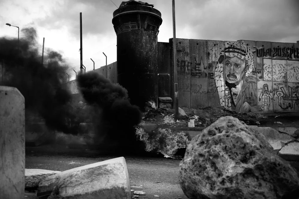  A murales of Yasser Arafat on the separation wall of the Qalandiya check point where often clashes between Israeli Police and Young Palestinians erupts. 