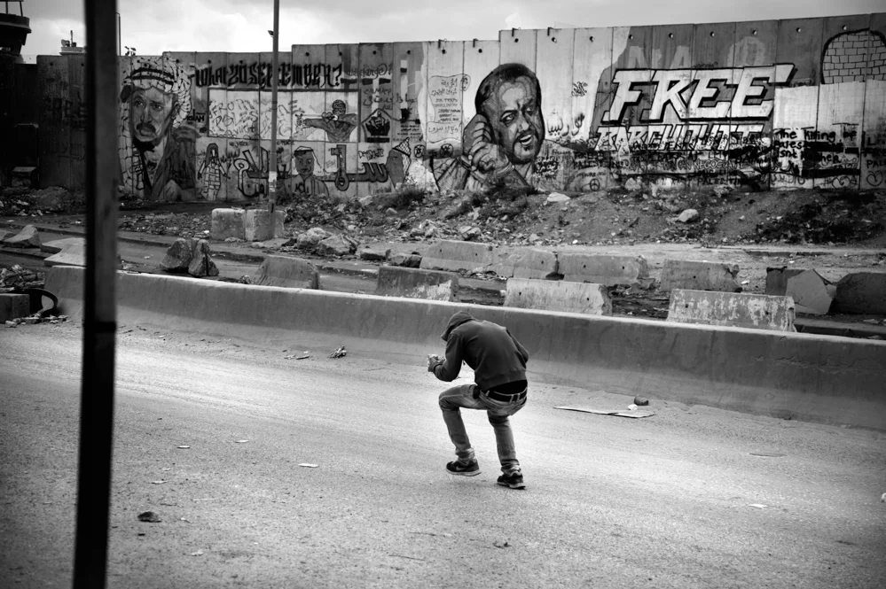  A young Palestinian is seen at the Qalandiya check point during clashes with the Israeli Police. 
