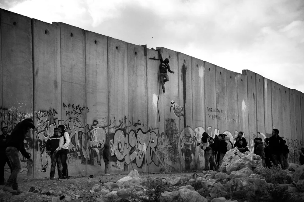  Young Palestinians at the separation wall of Qalandiya check point 