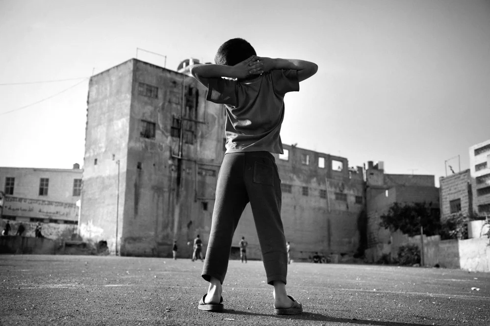  Palestinian children playing football in the old city of Hebron. 