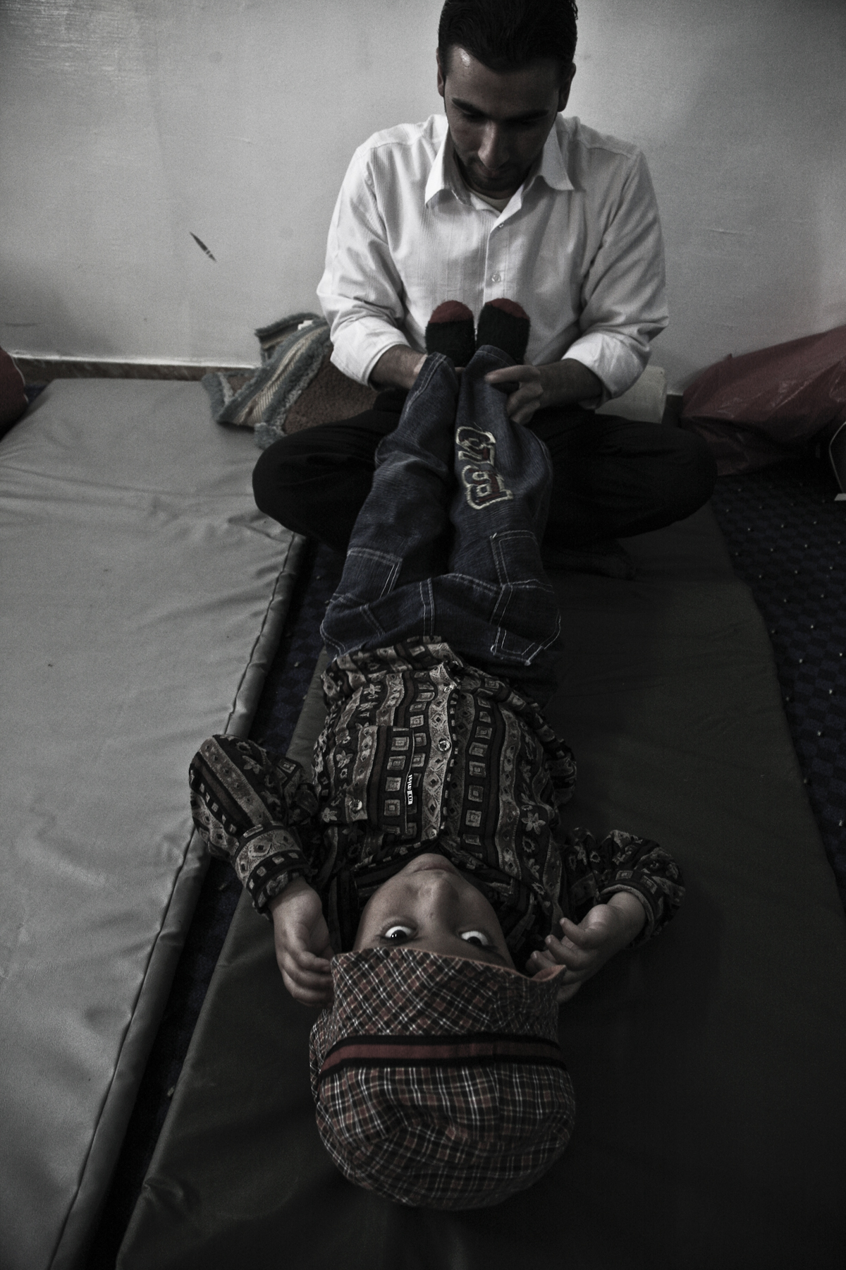Naseem at the Disability Recourse Information Center during a rehabilitation session. He suffers from paraplegia caused by water on the brain. Naseem receives rehabilitation therapy three times a week at the Disability Recourse Information Center in