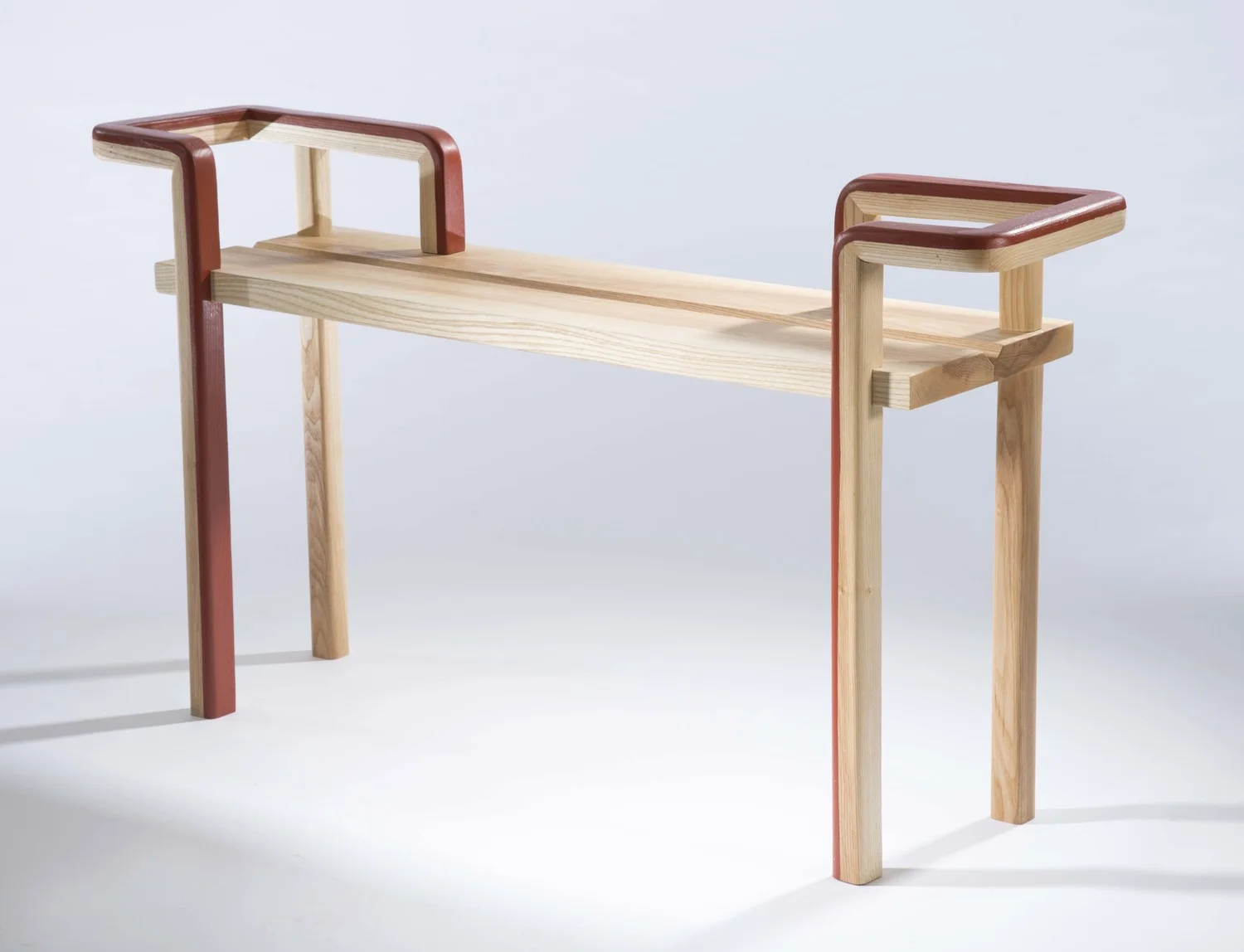  Maple wood and burnt orange paint  This burnt bench is the result of a formal exploration in creating fluid curves through solid woodworking and joinery.&nbsp;    