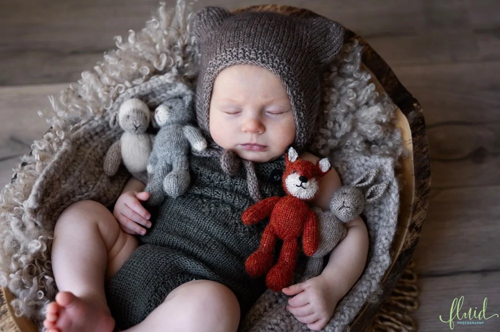 Baby with stuffed toys.