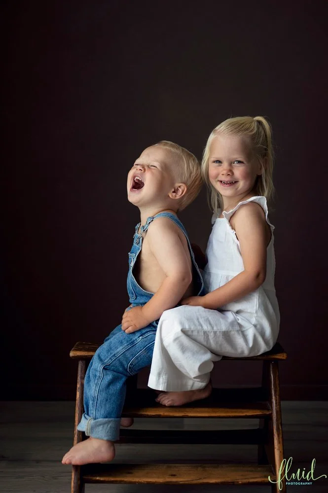 Brother laughing with sister.