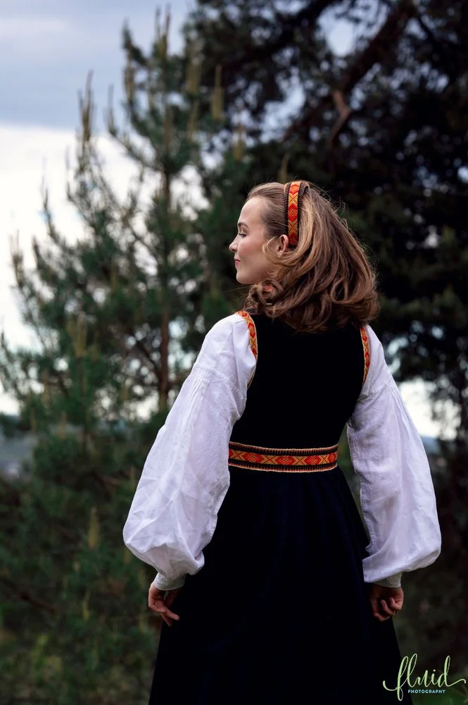Side portrait of girl in bunad.