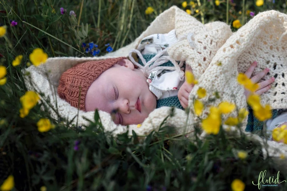 Baby in a bed of flowers.