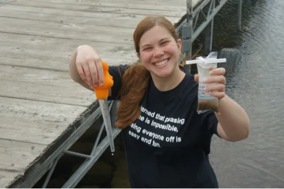 Dawn modeling the turkey baster used to take an epilithic diatom sample at Spirit Lake, Iowa.