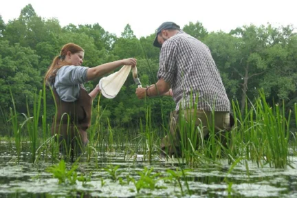 Dawn conducting a plankton tow in a peatland pool.