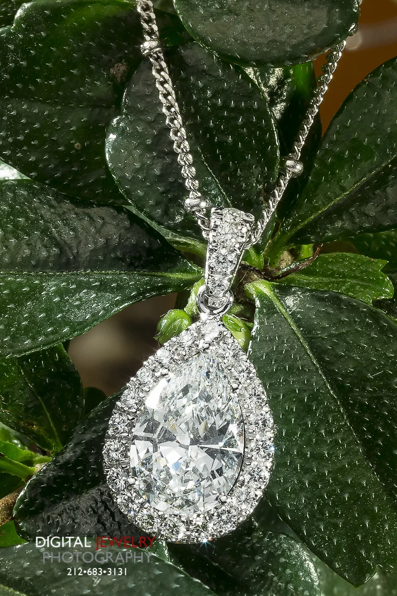 Diamond Pear Halo Pendant on Flower.jpg
