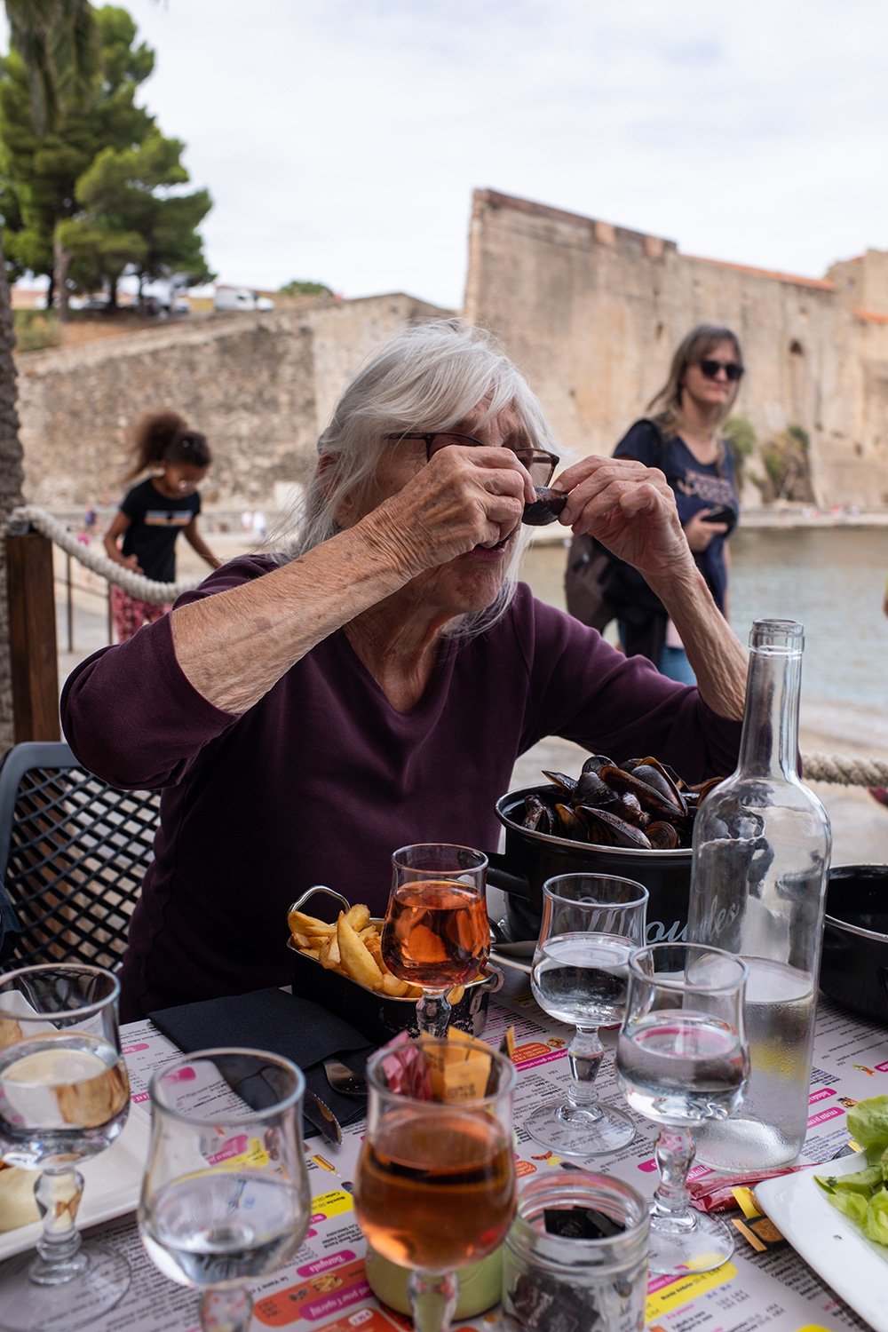 Anita eating oysters. Collioure, France, 2022