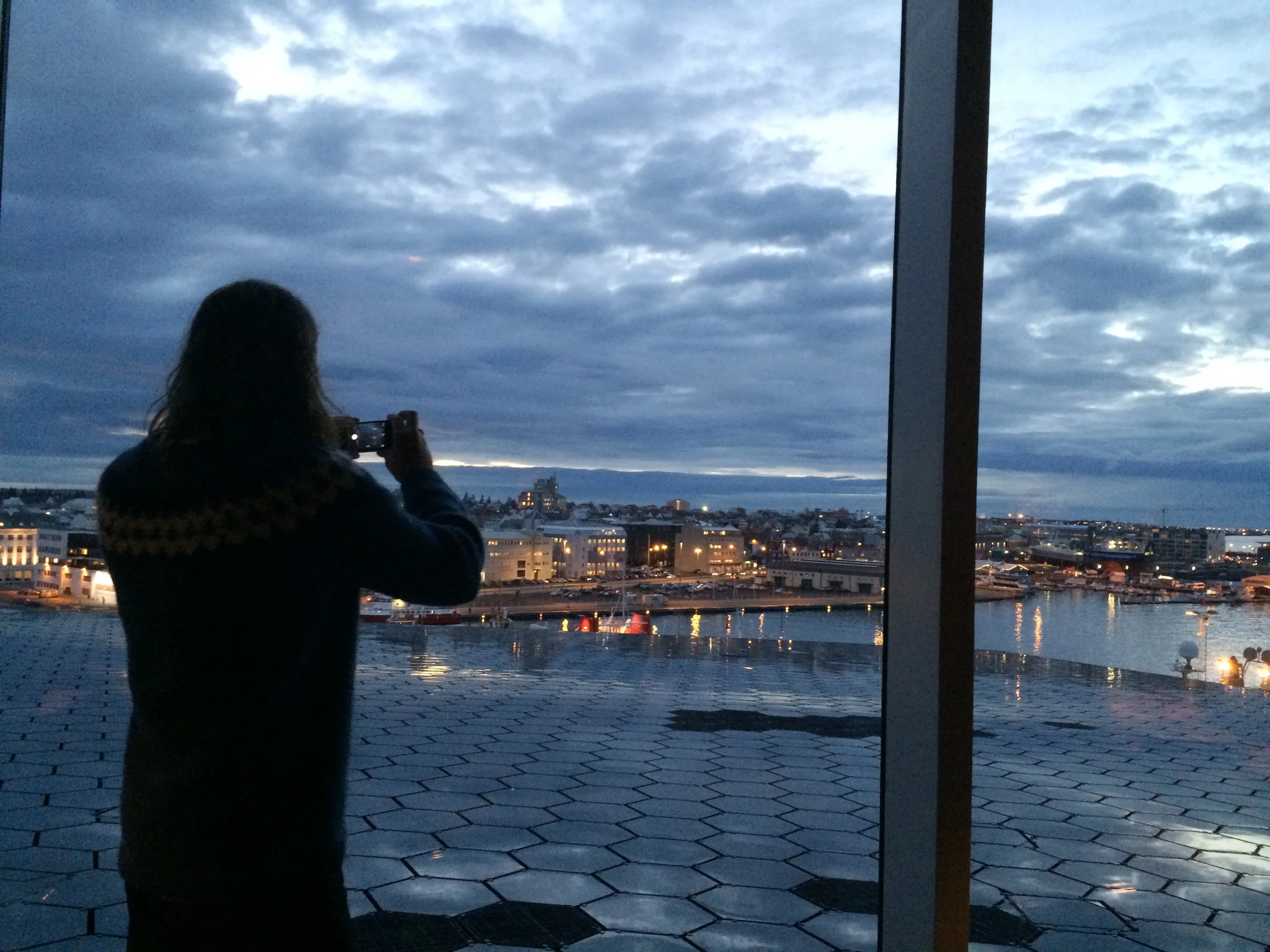 Jed taking a picture of Reykjavik, from Harpa