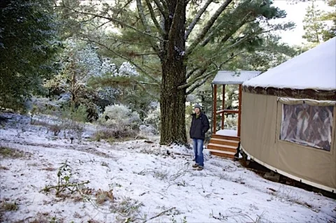 Lytle at first snow in front of the yurt he built in the Santa Cruz Mountains of Northern California