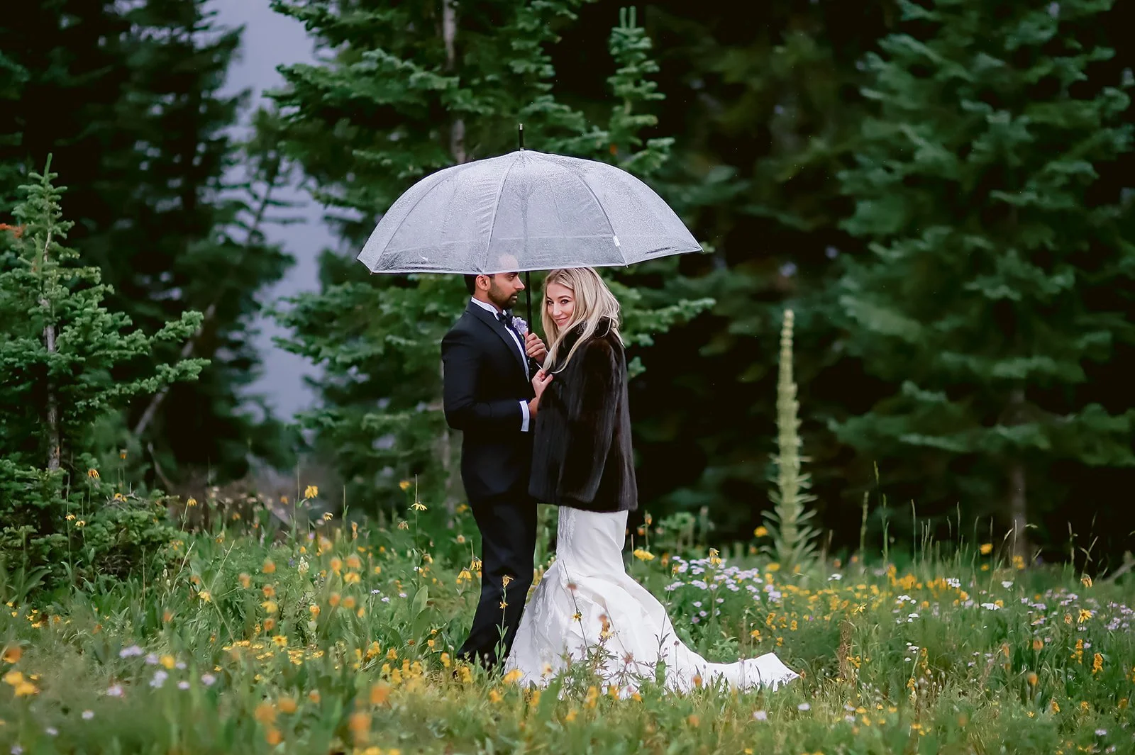 Bride and Groom under umbrella at Little Nell